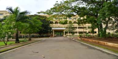 Tree-lined entrance driveway and portico of MIMER Medical College, Talegaon Dabhade