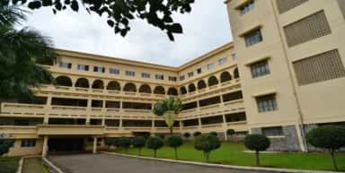 Courtyard view of the MIMER Medical College block with arched balconies, Talegaon Dabhade