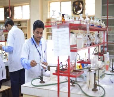 Students working at benches in a MIMER Medical College teaching laboratory