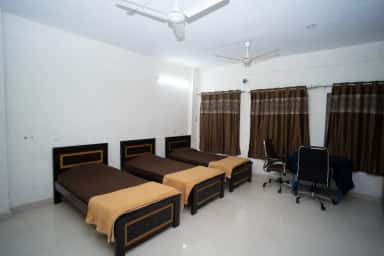 Multi-bed room with study chairs in the boys' hostel at Mamata Academy of Medical Sciences