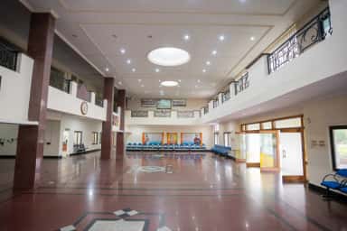 Double-height entrance lobby of Mediciti Institute of Medical Sciences with seating and skylight domes