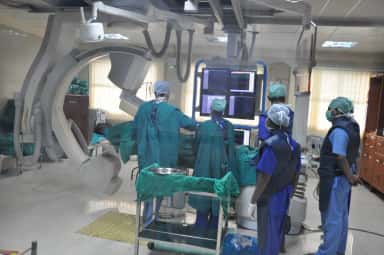 Surgical team at the cardiac catheterisation / C-arm suite of Meenakshi Medical College Hospital, Kanchipuram