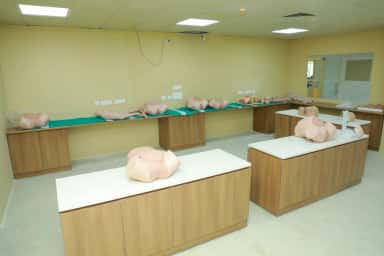 Procedure-training mannequins set up on benches in the simulation laboratory of Meenakshi Medical College, Kanchipuram