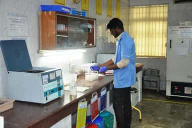 Laboratory technician at the centrifuge in the blood bank of Meenakshi Medical College Hospital, Kanchipuram