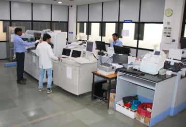 Central pathology and biochemistry laboratory at MGM Hospital, Aurangabad, with automated analysers and technicians at work