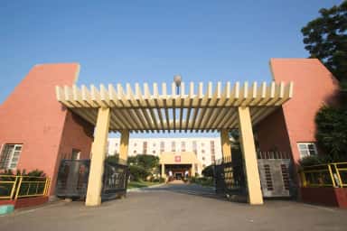 Entrance arch and gates of the Navodaya campus at Raichur with the college building behind