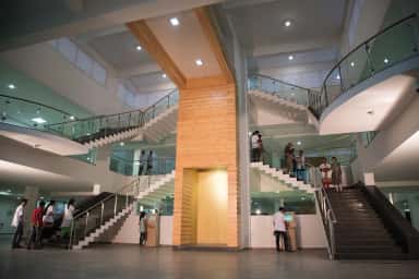 Multi-level atrium and staircases inside the Navodaya Medical College central library