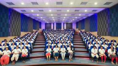 Navodaya Medical College auditorium filled with medical students in white coats
