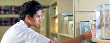 Student studying preserved specimens in the Navodaya Medical College museum