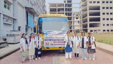 Nova Institute of Medical Sciences team with a college bus carrying the Family Adoption Programme banner