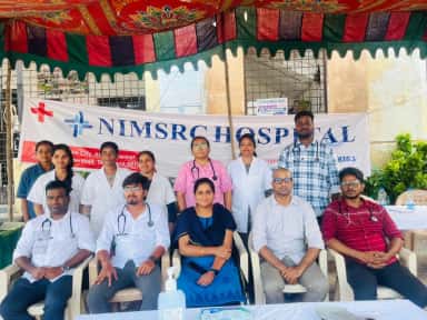 NIMSRC Hospital doctors and staff at a free medical camp under the hospital banner