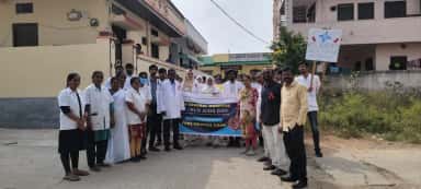 Students and staff of Nova Institute of Medical Sciences at a World AIDS Day awareness rally with the NIMSRC banner