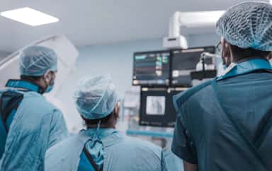 Surgical team reviewing monitors during a procedure at Parul Sevashram Hospital, Vadodara