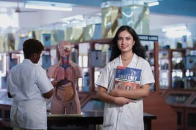 MBBS students beside a human anatomy model in the anatomy museum at Parul Institute of Medical Sciences & Research, Vadodara