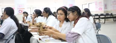 Students studying a skull specimen in the anatomy room at PESUIMSR