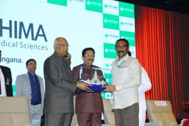 Memento presentation to President Ram Nath Kovind on the Prathima Institute of Medical Sciences stage, Karimnagar