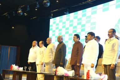 Dignitaries standing on stage at the Prathima Institute of Medical Sciences auditorium during the Presidential visit on 22 December 2018
