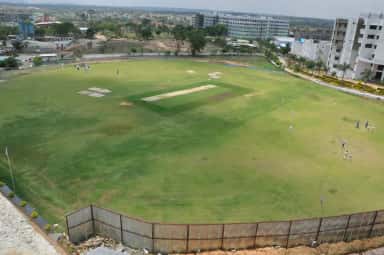 Aerial view of the cricket ground and campus blocks at RajaRajeswari Medical College, Bengaluru