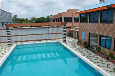 Open-air swimming pool beside the fitness centre block at RajaRajeswari Medical College, Bengaluru