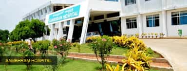 Sambhram Hospital entrance at KGF with Kannada and English signage and landscaped gardens (archived college photo, 2024)