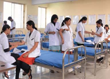 Medical students practising clinical examination on ward-style training beds at Sapthagiri Institute of Medical Sciences, Bengaluru