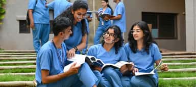 MBBS students of SDM College of Medical Sciences Dharwad studying together on the campus lawns