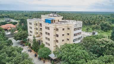 Aerial drone view of a hostel block at Shridevi Institute of Medical Sciences Tumkur amid coconut groves