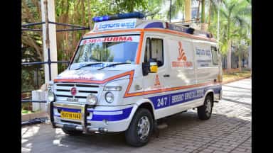 Siddaganga Hospital 24/7 emergency ambulance parked on the Tumakuru campus