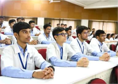 MBBS students in white coats seated in a lecture hall at SMBT Institute of Medical Sciences, Nandi Hills