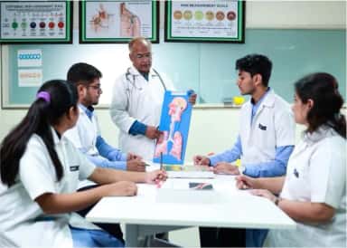 Faculty member teaching a small group of students with a respiratory-system model at SMBT Institute of Medical Sciences