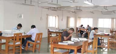 Reading hall of the Smt. Kashibai Navale Medical College central library with students at study tables