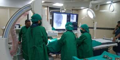 Interventional procedure under a C-arm in the cath lab at Smt. Kashibai Navale General Hospital