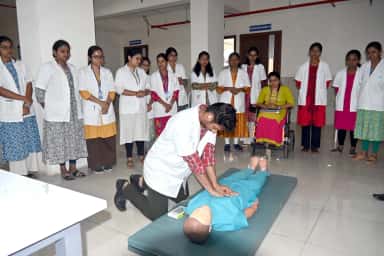 MBBS students in white coats practising CPR on a manikin in the skill laboratory at SR Patil Medical College