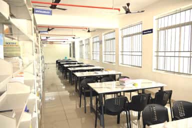 Reading hall of the central library at SR Patil Medical College with department book stacks
