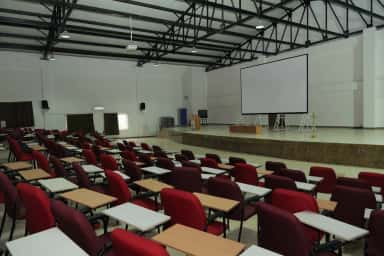 Auditorium with stage and projection screen at Sri Chamundeshwari Medical College, Channapatna