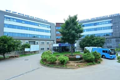 Modern glass-fronted block of R.L. Jalappa Hospital and Research Centre, the teaching hospital of Sri Devaraj Urs Medical College