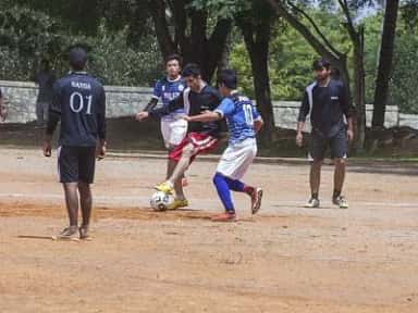 Students playing football on the sports ground of the SDUAHER campus at Tamaka, Kolar