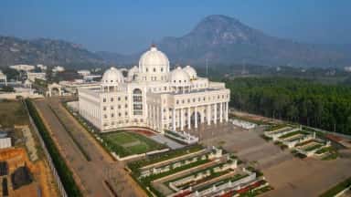 Aerial view of the SMSIMSR academic building and gardens against the Muddenahalli hills