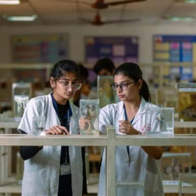 Two medical students examining preserved specimens in the anatomy and pathology museum at Sri Ramachandra Medical College, Chennai