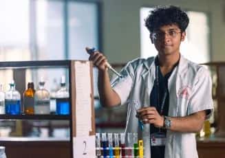 A medical student using a micropipette and test tubes in a biochemistry laboratory at Sri Ramachandra Medical College, Chennai