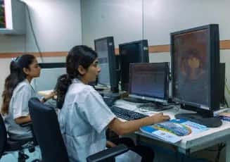 Medical students at radiology workstations reviewing imaging scans at Sri Ramachandra Medical College, Chennai