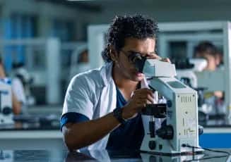 A medical student using a microscope in a pathology / microbiology laboratory at Sri Ramachandra Medical College, Chennai