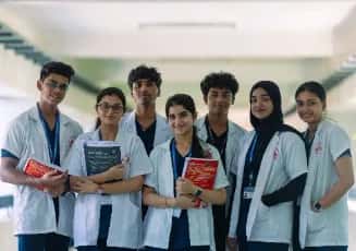 A group of MBBS students in white coats on campus at Sri Ramachandra Medical College, Chennai