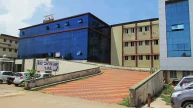 Srinivas Hospital building with outpatient department signage at Mukka, the teaching hospital of Srinivas Institute of Medical Sciences