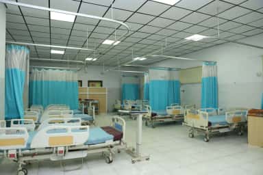 Emergency ward with hospital beds and curtains at SRM Medical College Hospital and Research Centre