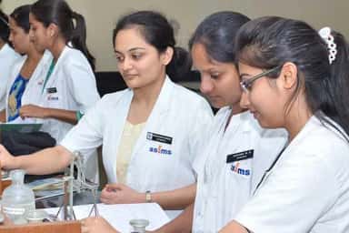 Students in SSIMS-badged white coats during a practical session at S S Institute of Medical Sciences, Davangere
