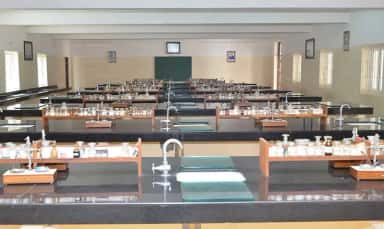 Rows of laboratory benches with reagent racks in a practical hall at S S Institute of Medical Sciences, Davangere