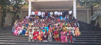 Teaching faculty of SVS Medical College seated on the campus steps during an educational visit
