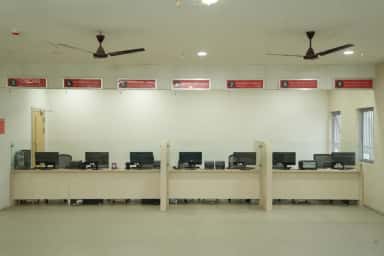 Numbered registration counters including CMCHIS and new-registration desks at Takshashila Medical College Hospital