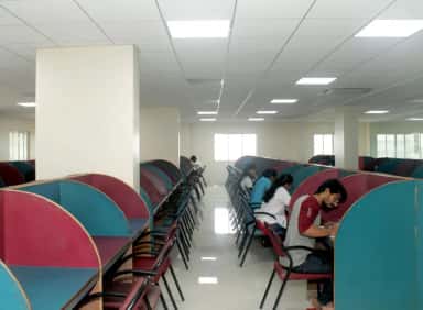 Students studying at individual reading carrels in the central library reading hall of Terna Medical College, Navi Mumbai